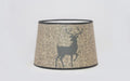 Bring a touch of rustic charm to any lamp. This new shade from Aladdin features a majestic buck deer silhouette on a warm burlap textured background. 12" base diameter, this style of Parchment (Paper) shade does not have a built-in tripod. 12" tripod/shad